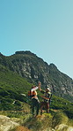 Trekking, men and high five for success on mountain for goal, target or achievement on adventure. Hiking, friends and people with fist pump outdoor for celebration, yes or happy with mockup space