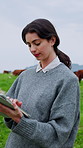 Woman, research and tablet on farm with cattle, typing report and check livestock for sustainability. Countryside, farmer and female person outdoor with tech for agriculture, cows and dairy business.