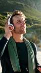 Fitness, man and headphones outdoor with phone, workout break and app for listening to music playlist. Active, happy person and wellness in nature with audio tech, exercise rest and rhythm with song.