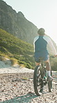 Back, man and fitness in nature with mountain bike, sports training and gear for endurance challenge. Active, person and cycling outdoor on rocky terrain with bicycle, helmet or exercise for wellness