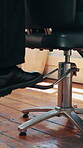 Barber, foot and pedal with customer in chair for appointment, haircut or height adjustment. Change, service and small business with people at hairdresser for consulting, hair maintenance or styling