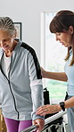 Physiotherapy, old woman or rail in hospital for balance, rehabilitation or injury recovery. Smile, physiotherapist or senior person with disability at bar, stability or instruction in consultation