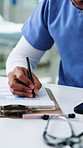 Nurse, hands and writing in hospital with clipboard, paperwork or patient info for health insurance. Healthcare worker, man and documents in clinic for medical aid, form and application for policy.