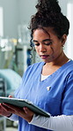 Nurse, woman and scroll in hospital with tablet, medical research and typing for telehealth chatbot. Healthcare worker, person and reading in clinic with tech, patient records and AI for admin tasks.