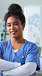 Nurse, face and arms crossed in hospital for healthcare, medical professional and department about us. Smile, woman and employee in clinic with confidence, service minded and happy for opportunity