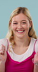 Excited, omg and face of woman in studio with good news, announcement or deal for prize. Happy, giveaway and portrait of person with celebration, wow or winning competition by blue background.