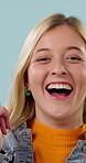 Thinking, happy and face of woman in studio with problem solving, solution or decision on creative career. Smile, choice and portrait of person with idea, planning or brainstorming on blue background