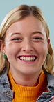Happy, omg and face of woman in studio with good news, announcement or deal for prize. Excited, giveaway and portrait of person with celebration, wow or winning competition by blue background.