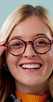 Face, woman and glasses in studio with eye care, satisfaction and surprise for vision improvement. Happy, person and shock for spectacles, clear eyesight or optometry for wellness on blue background.