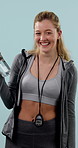 Face, fitness and laughing with personal trainer woman in studio for development or training. Funny, stop watch and water bottle with happy coach on blue background for health or workout session