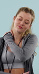 Neck pain, fitness and woman in studio with injury, accident or body inflammation for exercise. Sport, fatigue and person with hurt shoulder for muscle sprain, tension or arthritis by blue background