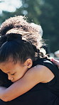Girl, hug and mom in graveyard for funeral, compassion or burial for death, support or crying with coffin. Child, embrace or sad kid in cemetery for grief, loss or mourning with father and empathy