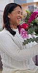 Celebration, mom and girl in house with flowers, bonding together and floral gift in special moment. Happy, parent and daughter with loving hug, bouquet present and family connection on Mothers Day.