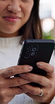 Text message, smile and hands in home with phone, internet search and communication on online platform. Happy, digital and woman in house with tech, social media update and chatting on virtual app.