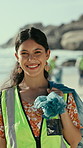 Face, volunteer and happy woman on beach for cleaning, recycling and collect waste for earth day. Smile, portrait and person with trash bag for environment, reduce pollution or climate change for ngo