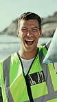 Face, volunteer and excited man on beach for cleaning, recycling and plastic for earth day. Laugh, portrait and happy person with trash bag for environment, reduce pollution or climate change for ngo