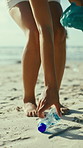 Woman, hands or cleaning beach with bottle for recycling plastic, save planet or earth day. Female person, volunteer or cleaner with dirt for community service or environmental hygiene on sandy shore