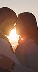 Forehead touch, sunset and love with couple at beach for romantic getaway, vacation and connection. Anniversary holiday, travel and flare with man and woman outdoor for date, loyalty and trust