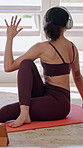 Yoga, woman and online class in house with headphones, tablet and watch video tutorial for stretching. Person, exercise and fitness in living room with audio tech, virtual lesson and spinal twist.