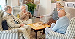 Group, conversation and elderly people in retirement home with laugh, reunion and funny joke in lounge. Smile, friends and happy together for memory, bonding and comic chat on sofa in living room