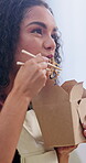 Fast food, eating and noodles with woman in home for chinese takeaway, nutrition and lunch. Chopsticks, happiness and hungry with person and order in living room in house for meal, cuisine and relax