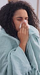 Sick, tissue and blowing nose with woman in home for influenza, viral infection and fatigue with disease. Illness, virus and blanket with person in living room in apartment for fever and exhausted