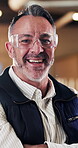 Carpenter, glasses and face of man in warehouse for woodworking, factory manager and pride. Timber craftsman, smile and furniture production with mature person in workshop for manufacturing and laugh