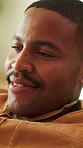 Black man, calm and relax in house, thinking and smile with positive mindset for peace on weekend. Break, chill and happy male person at apartment with thoughts, vision or perspective with reflection