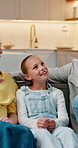 Home, happy kid and relax with parents, bonding and storytelling with conversation on break. Smile, mother and father with girl on sofa, listening or care with family support for child development