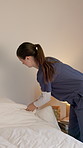 Caregiver, woman and making bed in nursing home, cleaning and bedding change for hygiene in bedroom. Assisted living, medical professional and person with fresh blanket, tidy and healthcare services