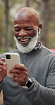 Phone, earbuds and black man in park for texting, chatting or social media with fitness advice. Technology, laugh and mature person with cellphone for sports blog or article on app for exercise
