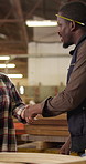 Carpenter, team and handshake in workshop with conversation, tablet and planning furniture design. Designer, people and shaking hands in factory with tech, discussion or artisan for woodwork project.