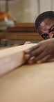 Carpentry, measure and man with dust for woodworking, furniture project and timber production. Carpenter, workshop and African person blow sawdust for manufacturing, renovation and lumber inspection