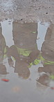 Puddle, reflection and engineer at construction site with team, check foundation and wet concrete. Above, meeting and people outdoor by water to review safety, engineering and structural integrity.