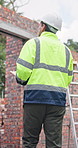 Construction, clipboard and man with walk, site check and quality control for building project. Industrial, back and engineer with review checklist, progress track and evaluation in risk assessment.