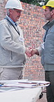 Men, architect or meeting with handshake on construction site for building plan or design. Male people, civil engineer or shaking hands with contractor or partnership for architecture project or deal
