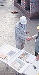 Architect, team or partnership with handshake on construction site for building plan or design. Top view, male people or civil engineer shaking hands for b2b meeting, architecture project or deal