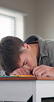 Tired, high school and teenager in classroom with wake up for test, exam or quiz for learning. Education, bored and boy student writing notes for studying with academic fatigue, burnout or exhaustion