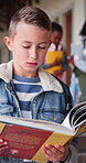 Reading, book and future with child in school hallway for education, knowledge and academy. Study, literacy development and growth with student in corridor of campus for scholarship and project