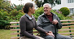 Happy, caregiver and holding hands with old man at park, bonding or healthcare for patient with cane. Outdoor, nurse and comfort for senior person with disability, trust and laugh together in nature