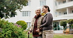 Caregiver, smile and old woman with cane at park, pointing or healthcare service for senior patient. Happy, nurse and support for elderly person with disability, bonding and together in nature