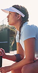 Woman, thinking and racket on tennis court with bench, contemplation and game plan for competition. Active, female person outdoor and reflection with sports gear, tactical idea or fitness for contest