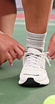 Woman, hands and shoelace on tennis court for match start, preparation and routine for player safety. Athlete, female person and secure sneakers outdoor for fitness, practice or beginning sports game