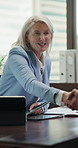 Woman, smile and handshake in agency for welcome, business agreement or document for finance. Investor, mature agent or shaking hands in office for investment deal, introduction or settle negotiation