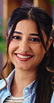 Wellness, face and woman in living room with smile, positive attitude and unwind with weekend break. Wellbeing, portrait and happy person in home with confidence, good mood or satisfaction on day off