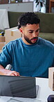 Box, laptop and remote work with man in home office for delivery, distribution or shipping. Computer, supply chain and tracking with person at desk in apartment for ecommerce or logistics business