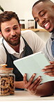 Barista, men and talk with tablet in cafe for website reviews, online sales and menu update. Small business, server or happy team with app for inventory management, restaurant rating or work schedule