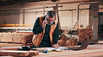 Carpentry, writing and man with phone call in workshop for project quote, new client or consultation. Paperwork, mature carpenter and mobile chat for design discussion, pricing notes and negotiation