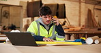 Carpentry, blueprint and man with phone call in workshop for custom project, clarify design or talk. Carpenter, floor plan and mobile chat in warehouse for cabinetry layout, feedback and shopfitting