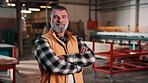 Carpentry, face or man in factory with arms crossed, tradesman or pride in manufacturing industry. Smile, portrait or mature artisan with confidence, craftsman or about us in woodworking profession.